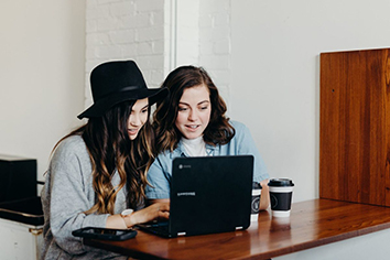 two women working on a computer